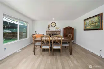 So many possibilities to make this space your own, centered around a wood fireplace with a classic brick mantel