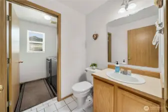 Convenient guest bathroom adjacent to an attached laundry room