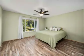 Spacious primary bedroom with abundant natural light and durable, easy-maintenance LVP flooring