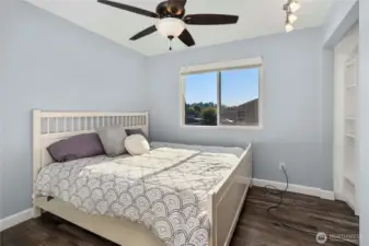 Bedroom #2 features modern paint colors, built-in storage, and a ceiling fan for comfort