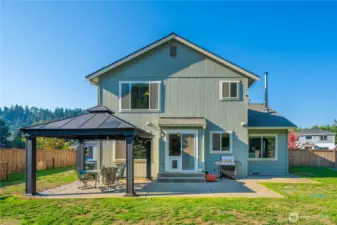 View of the home’s rear elevation and outdoor living spaces