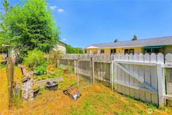 Garden area behind fence in back yard