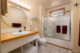 Second bathroom has tub, shower and tile floors