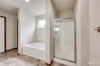 Primary bathroom features soaking tub and separate shower