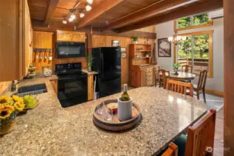 Shaker style cabinets with slab granite counters in this modernized kitchen.