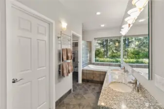 Primary bathroom with double sinks, jetted tub, heated towl rack