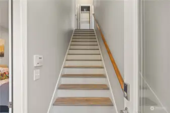 Separate staircase entrance to 2nd level apartment- can also access main house at top of stairs on the left. Laundry machines in that closet at the top of stairs