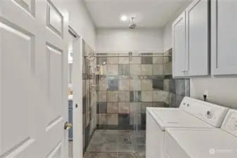 Main level walk-in tile shower with laundry