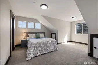 Bedroom located to the right of the stairs—large, bright, and comfortable
