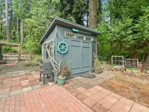 LOG SHED WITH PICNIC TABLE INSIDE