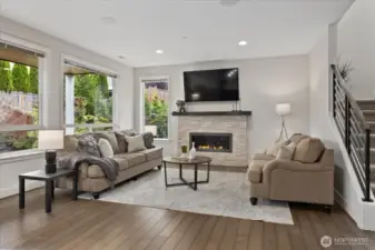 Enjoy cozy evenings by the gas fireplace with large picture windows allowing lots of natural light