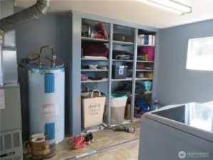 Utility room with storage - furnace and hot water tank located here.  Access to the filter room is from the outside.  Washer and dryer here to the right.