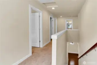 White two-panel interior doors. White faux-wood window blinds. Nice white millwork finishes.