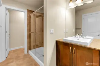 In the primary bathroom there is an oversized glass enclosed shower that is surrounded by tile, and the soaking tub has never even been used.  A window overlooking the backyard fills this bathroom with natural light. The toilet is located in a separate room for privacy.