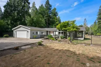 Spacious front yard and open lawn creates a peaceful, park-like setting. Plenty of paved parking and an oversized driveway provide convenience for guests, RVs, or extra vehicles.