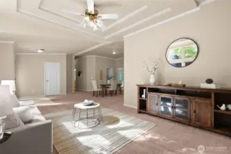 The neutral wall color create a warm, welcoming atmosphere, while the layout provides plenty of room for both formal seating and casual gatherings. It’s a versatile space perfect for entertaining or simply relaxing in comfort.