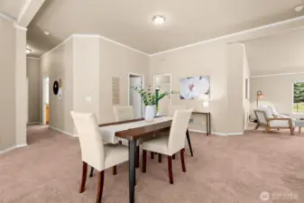 The dining area sits at the heart of the home. Its open design flows seamlessly into the living and sitting rooms, creating a natural gathering place.