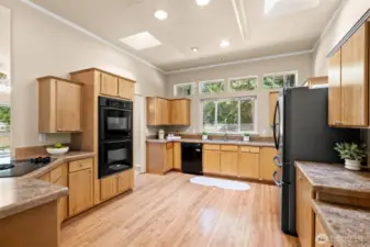 The open kitchen layout provides plenty of room for a breakfast table or the option to add an island—perfect for casual dining or entertaining.