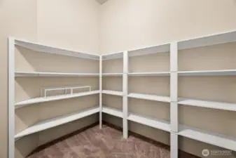 Spacious walk-in pantry is a dream for organized living—plenty of shelving to handle those big Costco runs, all your dry goods, and small kitchen appliances you don’t want cluttering the counters. A true storage bonus for everyday convenience and entertaining alike!