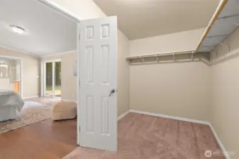 The oversized primary walk-in closet provides generous storage and organization, with plenty of space for wardrobes, shoes, and accessories—an ideal extension of the primary suite.