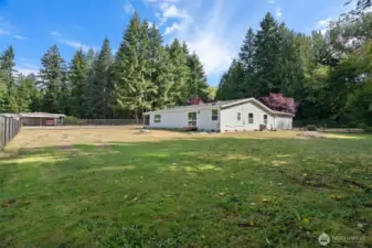 Another view of the fully fenced portion of the property, offering a secure and versatile outdoor space perfect for pets, play, gardening, or simply enjoying the peaceful setting.
