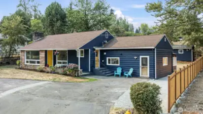 Convenient horseshoe driveway with easy in-and-out access, mature landscaping, and elevated curb presence.