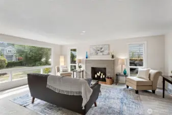 Oversized picture window anchors the room and brings in steady light from the front yard.