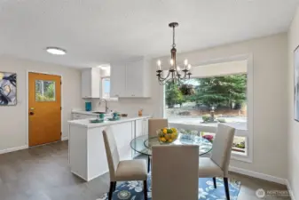 Bright and inviting, the dining area welcomes morning sun and frames the front yard through a wide east-facing window.