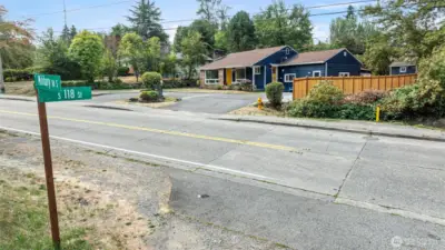 Before you even reach the porch, this home makes an impression: a hand-set stone address marker, goldfinch-yellow door, and bold navy trim—all set on a wide, 9,000-square-foot lot with new fencing and tidy landscaping. A confident sendoff before we head into the aerials.