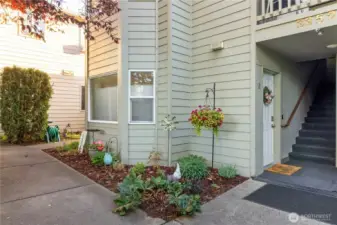Corner lower level unit with established landscaping.