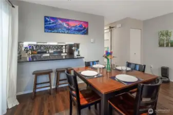 The kitchen has a pass-through to the dining area with a seating area.