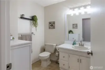 Large main bathroom with updated lighting & brushed nickel fixtures located about halfway down the hall to the bedrooms.