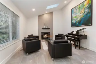 Living room on main level.  Expansive tiled wood-burning fireplace.