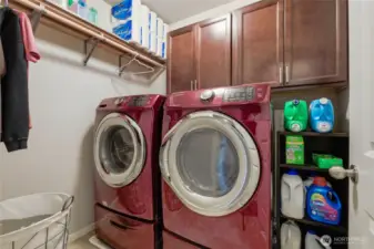 Laundry room with front load washer/dryer & storage