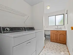 You also have the large utility room with 1/2 bath. Behind the walls is plumbing for a shower.