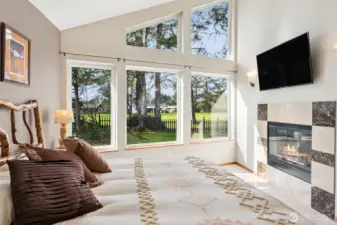Downstairs Primary Suite with floor-to-ceiling windows & fireplace