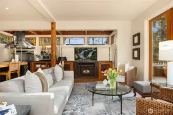 An intimate gathering living room with built in surround sound and TV.