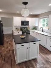 Kitchen with center island. Eating nook next to the center island.