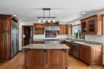 Fabulous gourmet kitchen with granite counters and luxurious custom cabinets...