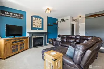 View of great room from eating space, door to powder room & garage.