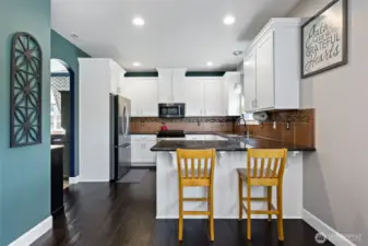 Another view of the kitchen and bar from eating space.