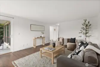 Living room with woodburning fireplace and territorial views over Interbay Golf Course and Queen Anne Hill.