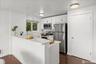 Kitchen with stainless steel appliances and large pantry.