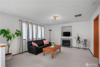 Large Family Room with gas fireplace for the cool winter evenings. Doorway to the right leads to laundry and garage.