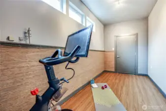Workout room tucked in off the garage, and adjoining access to upstairs.