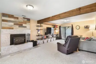 Lower level rec room is huge and features another woodstove