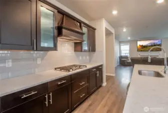 Gas range surrounded by beautful cabinets