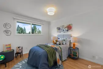 Second bedroom with beautiful east-facing morning light, comfortably fits a queen-sized bed.