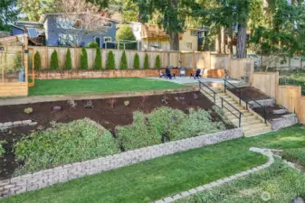Levelled terraced backyard includes this beautifully built green house.