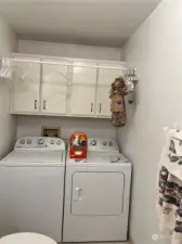 Laundry area & lots of cabinets located in the main bathroom.